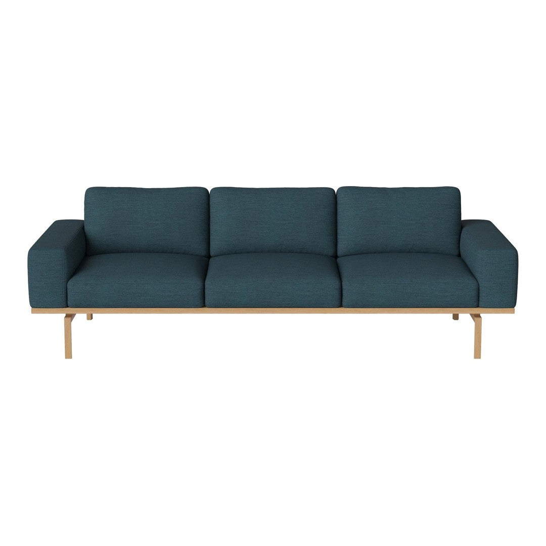 Teal upholstered sofa with a sleek, modern design and light wood frame, featuring simple lines and no visible patterns.
