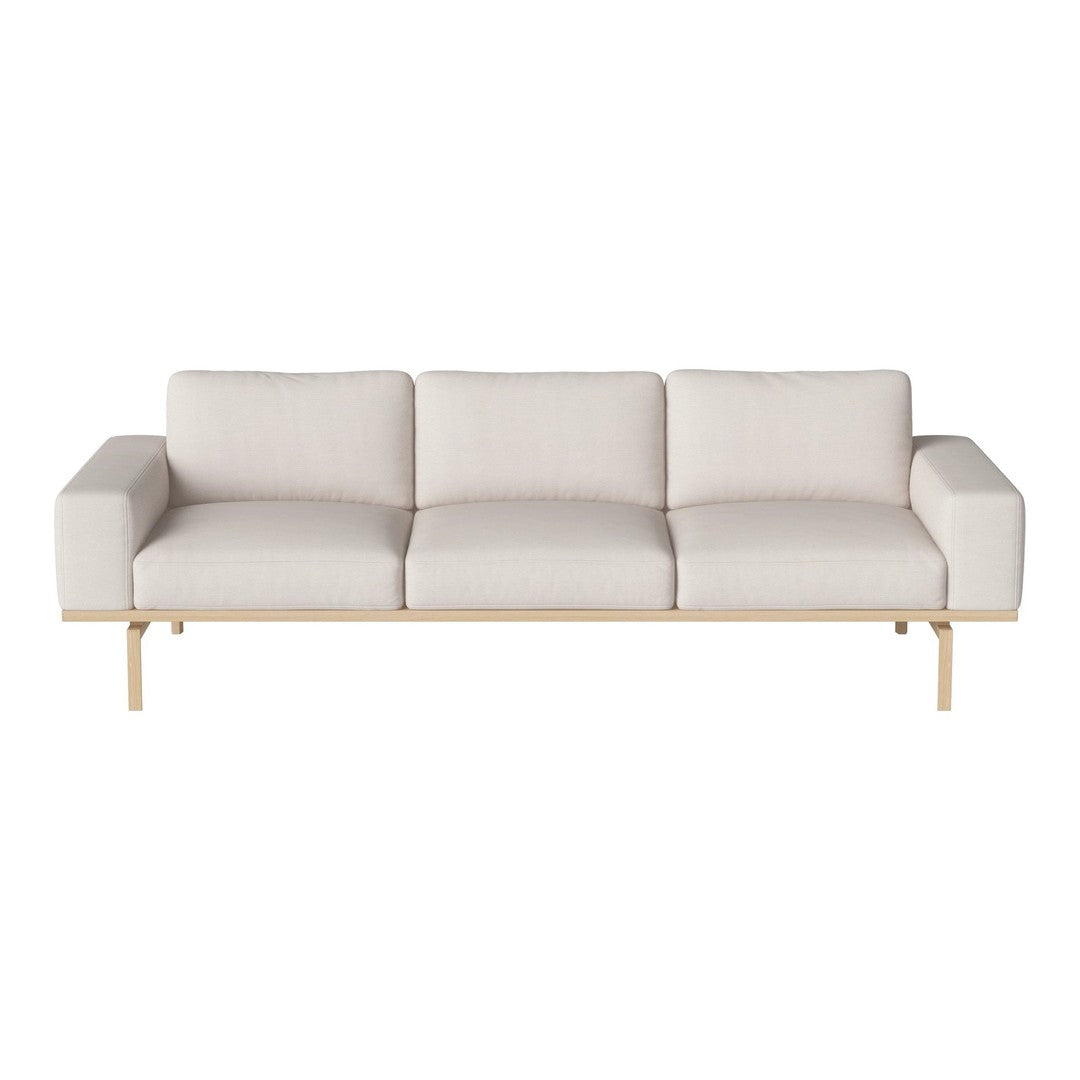 Light beige sofa with a minimalist design and subtle texture, featuring clean lines and a wooden base.