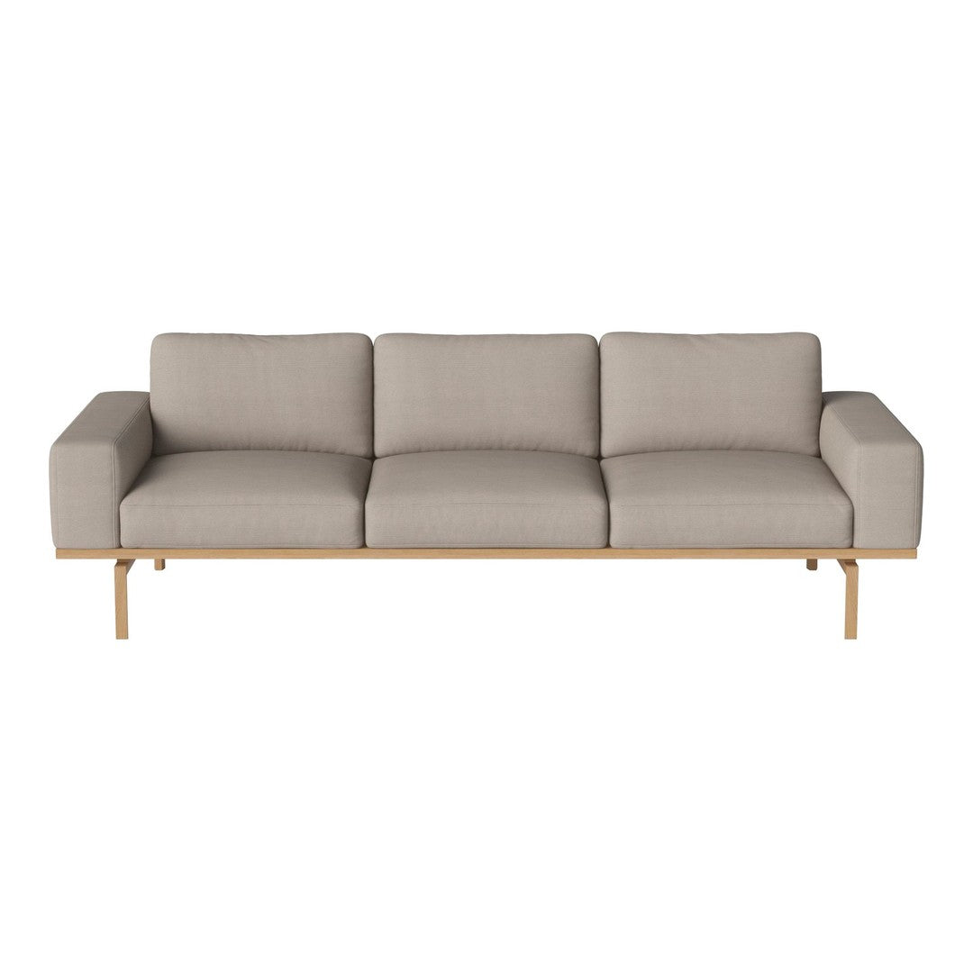 Light beige three-seater sofa with a modern design and smooth, minimalist upholstery. Natural wood legs add elegance.
