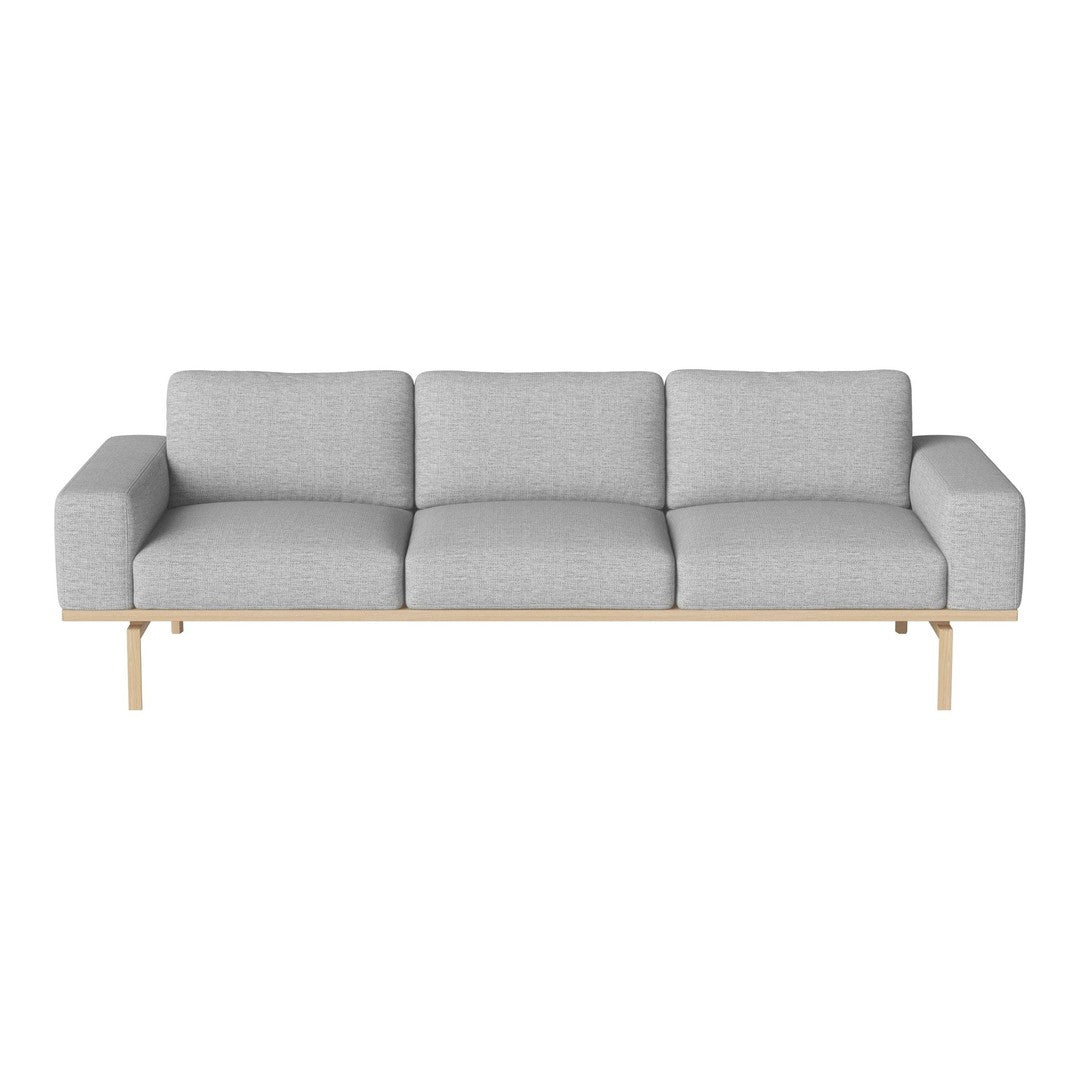 Light gray sofa with a minimalist design, featuring smooth fabric and a natural wood base. Perfect for modern decor.