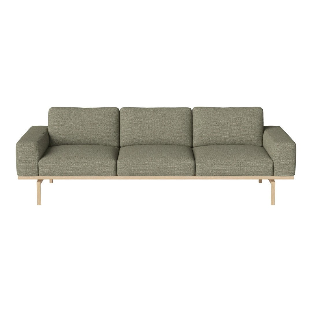 Contemporary green sofa with a textured pattern and light wooden legs, perfect for modern living spaces.