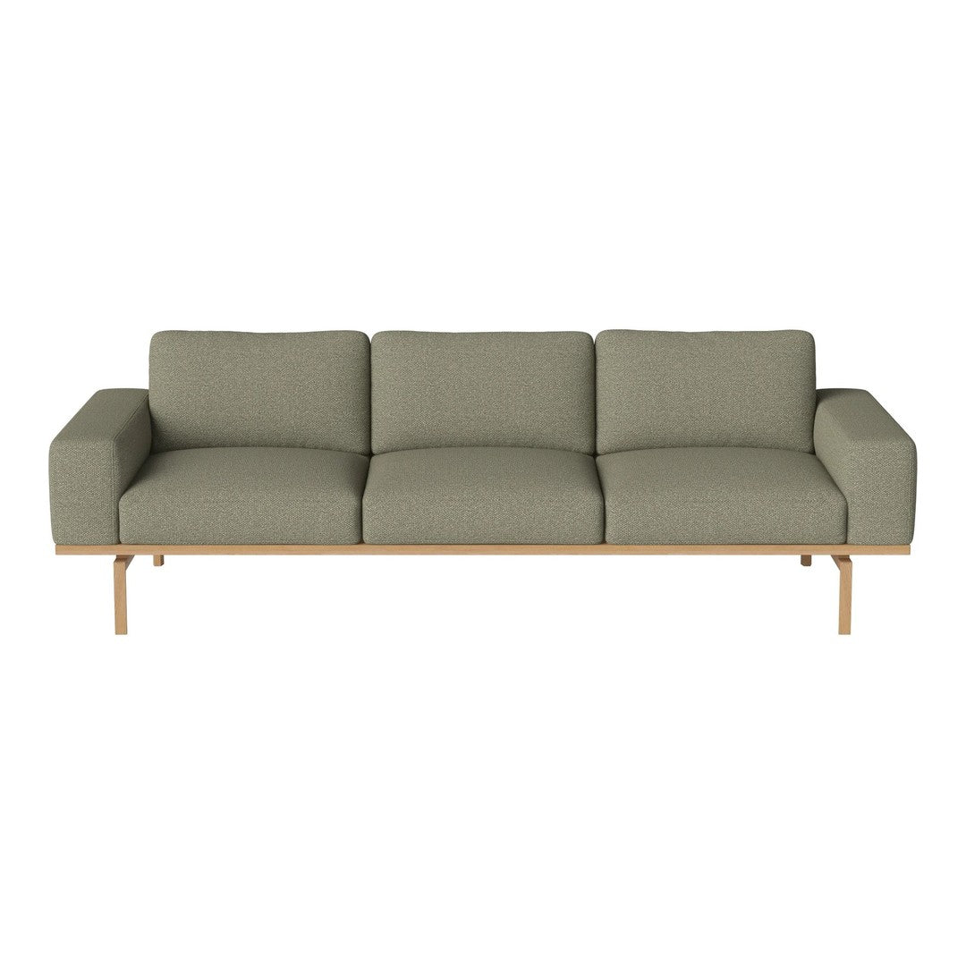 Olive green sofa with a modern design and linear pattern, complemented by a light wooden base.