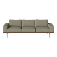 Sleek green sofa with a textured fabric and minimalist metal base, perfect for modern living spaces.