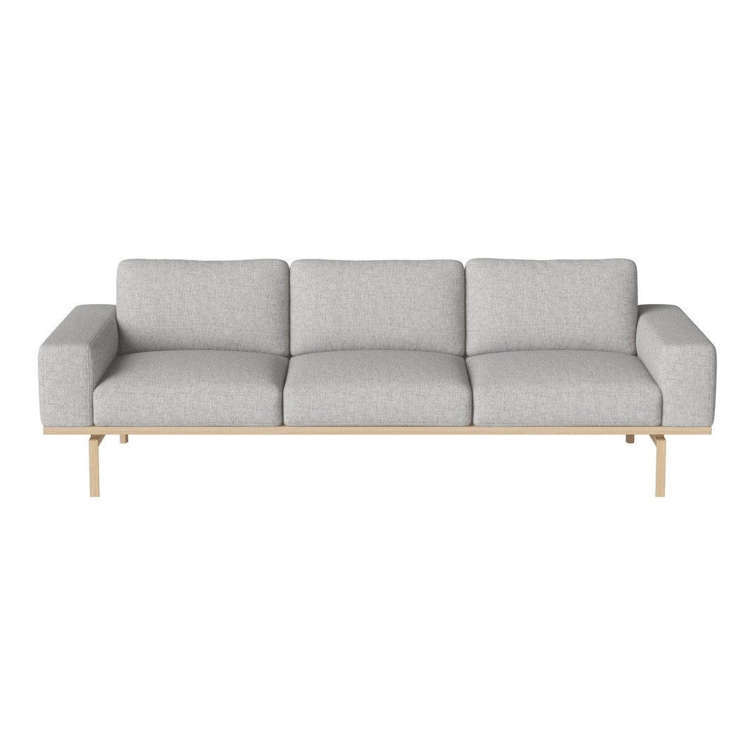 Light gray modern sofa with clean lines and soft fabric upholstery, accented by a natural wood base.