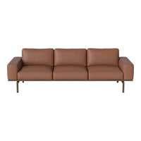 Brown leather sofa with a sleek design and clean lines, featuring subtle texture and a modern, minimalist aesthetic.