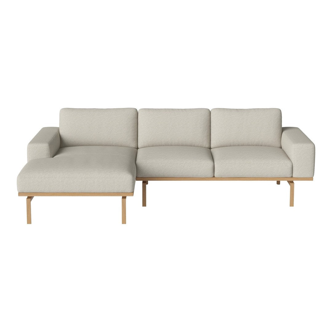 Light gray fabric sectional sofa with minimalist wooden legs, featuring a modern, clean design and textured upholstery.