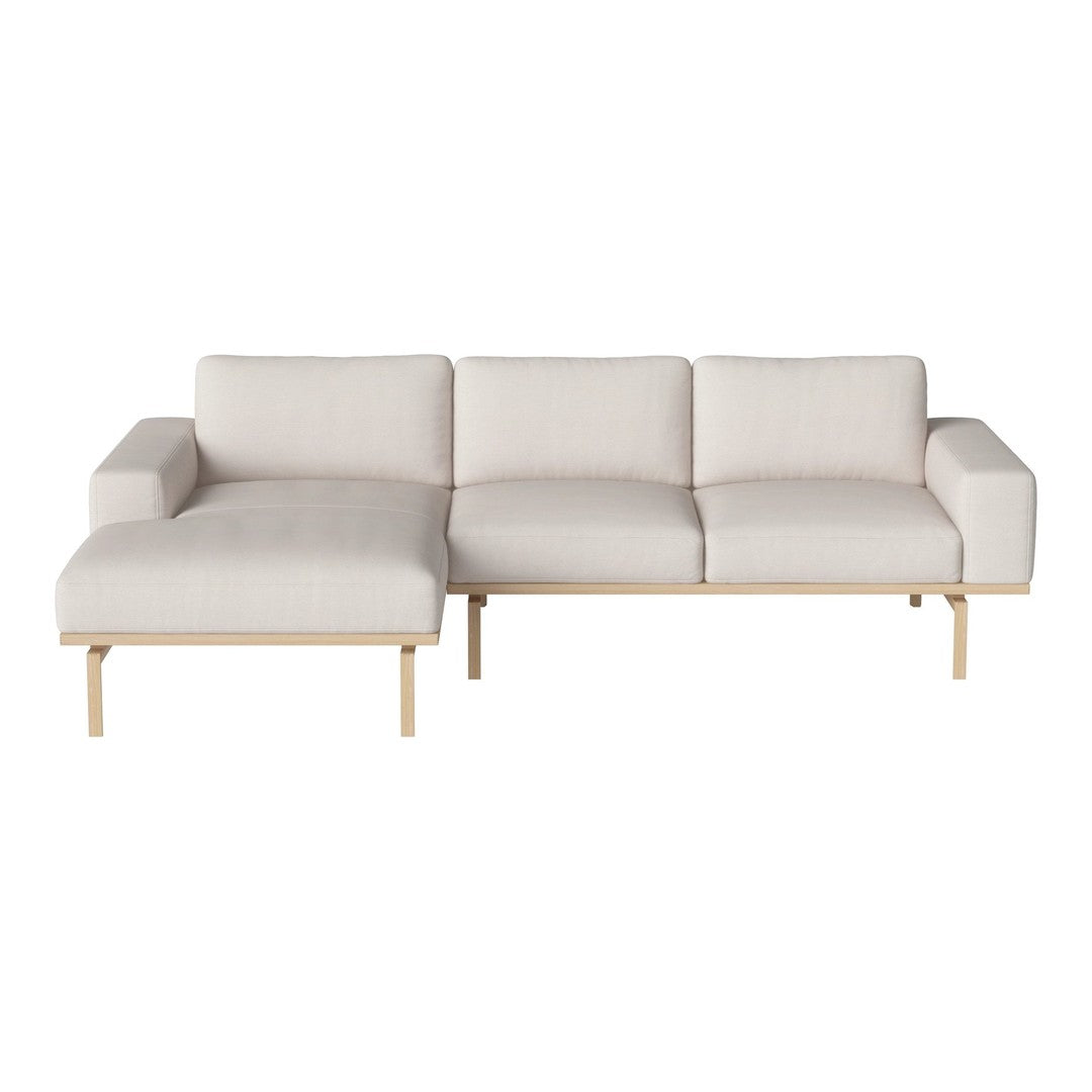 Light beige sectional sofa with minimalist design and a soft, textured finish.