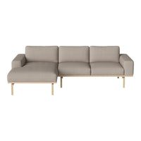 Light gray sectional sofa with smooth fabric and minimalist wooden legs, perfect for modern living spaces.