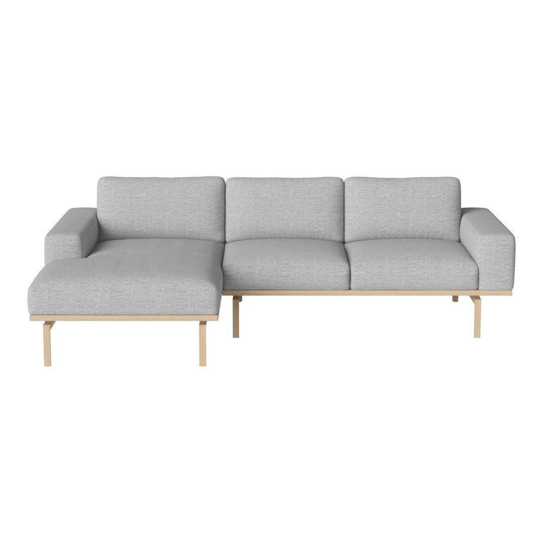 Light gray fabric sectional sofa with a minimalist design and wooden legs, perfect for modern living spaces.