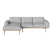 Light gray fabric sectional sofa with smooth lines and wooden legs, featuring a minimalist design.