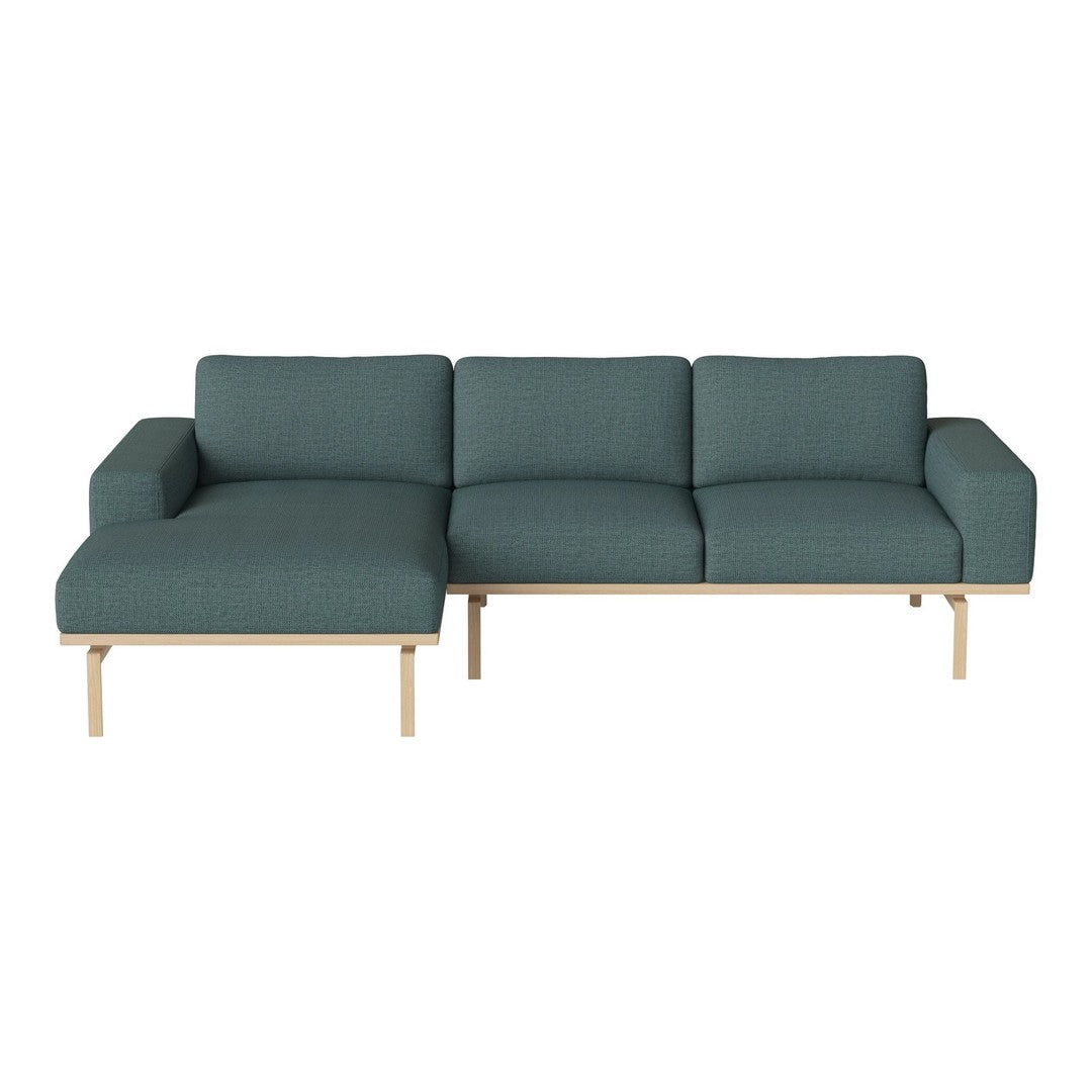 Teal fabric sectional sofa with clean lines and light wood legs, featuring a textured pattern for modern elegance.