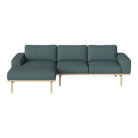 Teal fabric sectional sofa with clean lines and light wood legs, featuring a textured pattern for modern elegance.