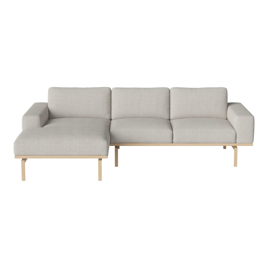 Light gray sectional sofa with clean lines and a minimalist design, featuring a smooth fabric texture and natural wood legs.