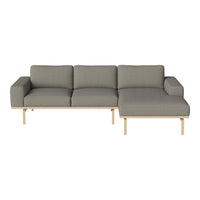 Gray sectional sofa with clean lines and a minimalist design, featuring wooden legs and fabric upholstery.