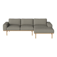 Gray fabric sectional sofa with a smooth texture and wooden legs, featuring a minimalist design.