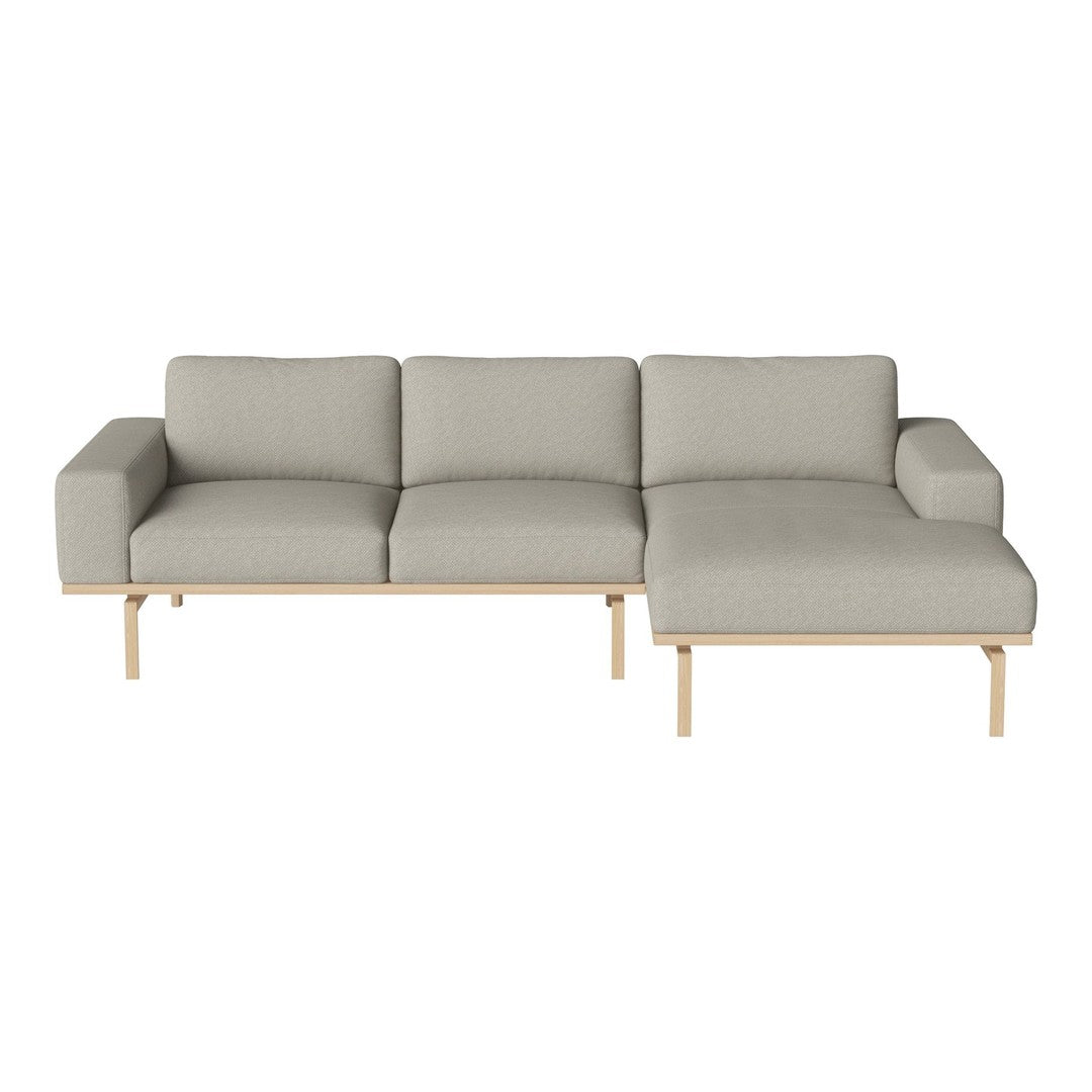 Light gray sectional sofa with a modern design, accented by clean lines and a natural wood base. Perfect for stylish living spaces.