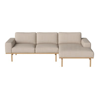 Beige fabric sectional sofa with clean lines and a minimalist design, featuring wooden legs and a contemporary aesthetic.