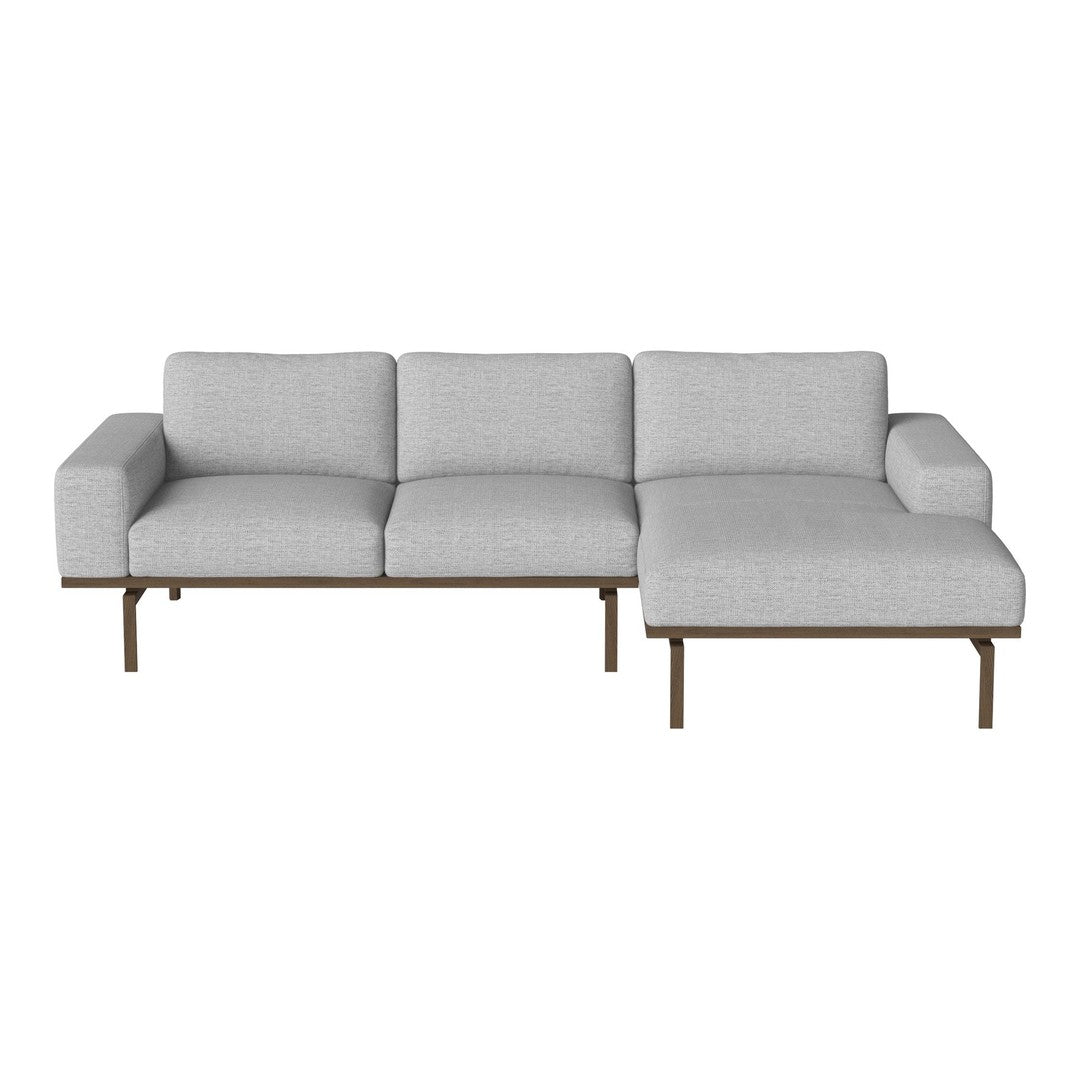 Light gray sectional sofa with a minimalist design and smooth fabric, featuring a modern wooden base.