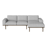 Light gray sectional sofa with a minimalist design and smooth fabric, featuring a modern wooden base.