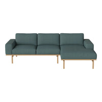 Teal upholstered sectional sofa with a subtle textured pattern and modern wooden legs. Perfect for any living space.
