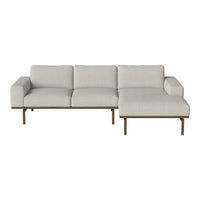 Light gray fabric sectional sofa with a minimalistic design and subtle texture, complemented by a sleek metal base.