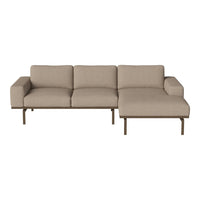 Beige upholstered sectional sofa with a clean design and subtle texture, featuring a sleek metal frame.