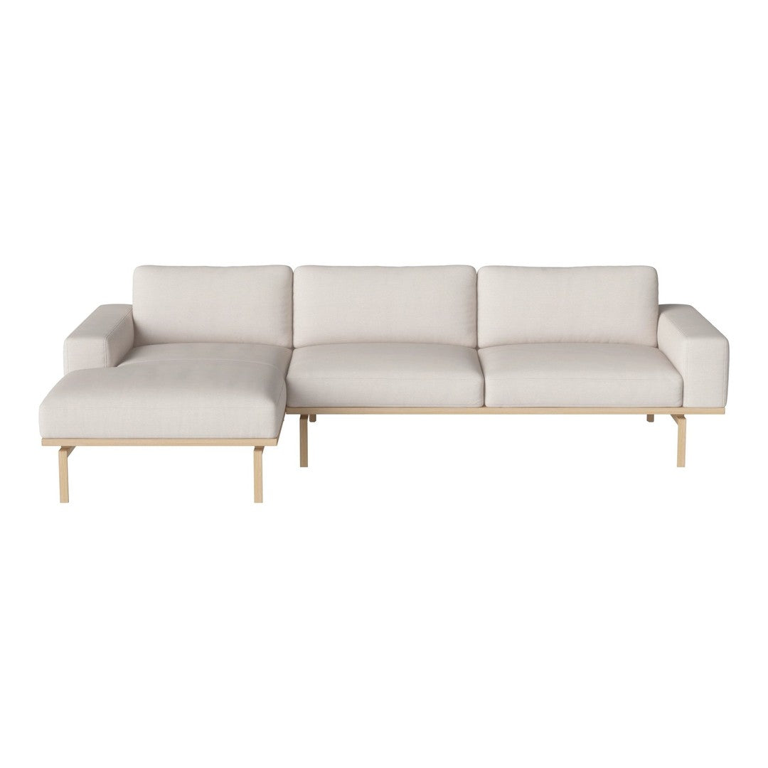 Light beige sectional sofa with a minimalist design and natural wood legs, featuring soft, solid upholstery.