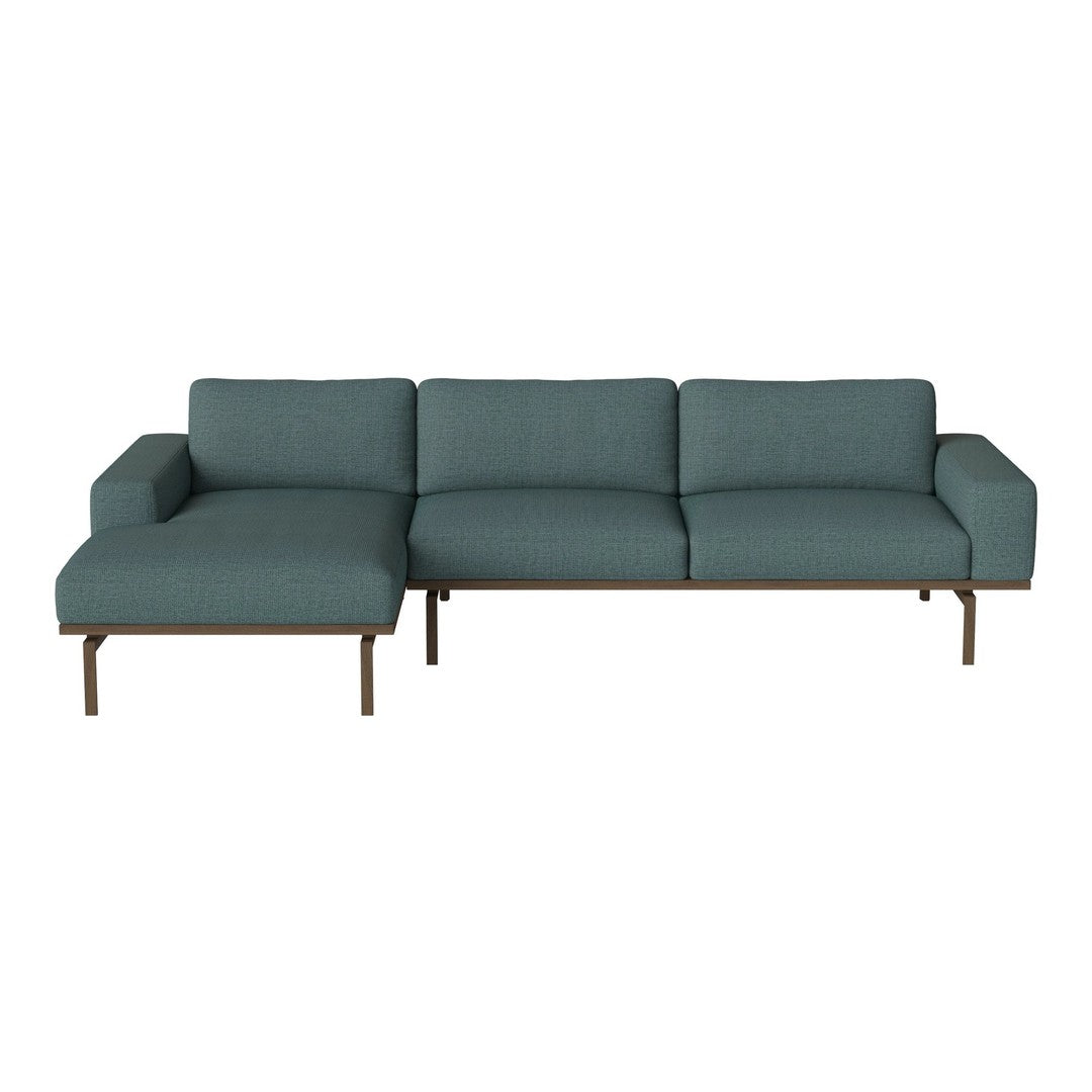 Modern teal sectional sofa with a minimalist design and smooth fabric, featuring a sleek metal frame.