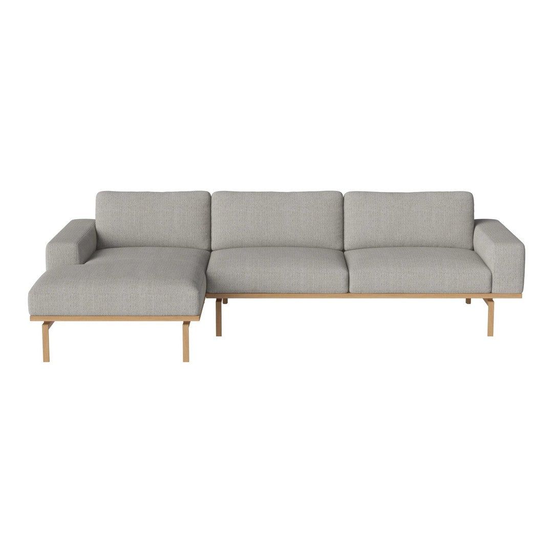 Light gray sectional sofa with a minimalist design and wooden legs, featuring a soft, smooth fabric texture.
