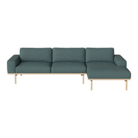 Teal fabric sofa with clean lines and light wood legs, featuring a minimalist design perfect for modern interiors.