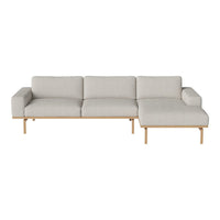 Light gray sectional sofa with a minimalist design and smooth fabric. Wooden legs add a natural touch.