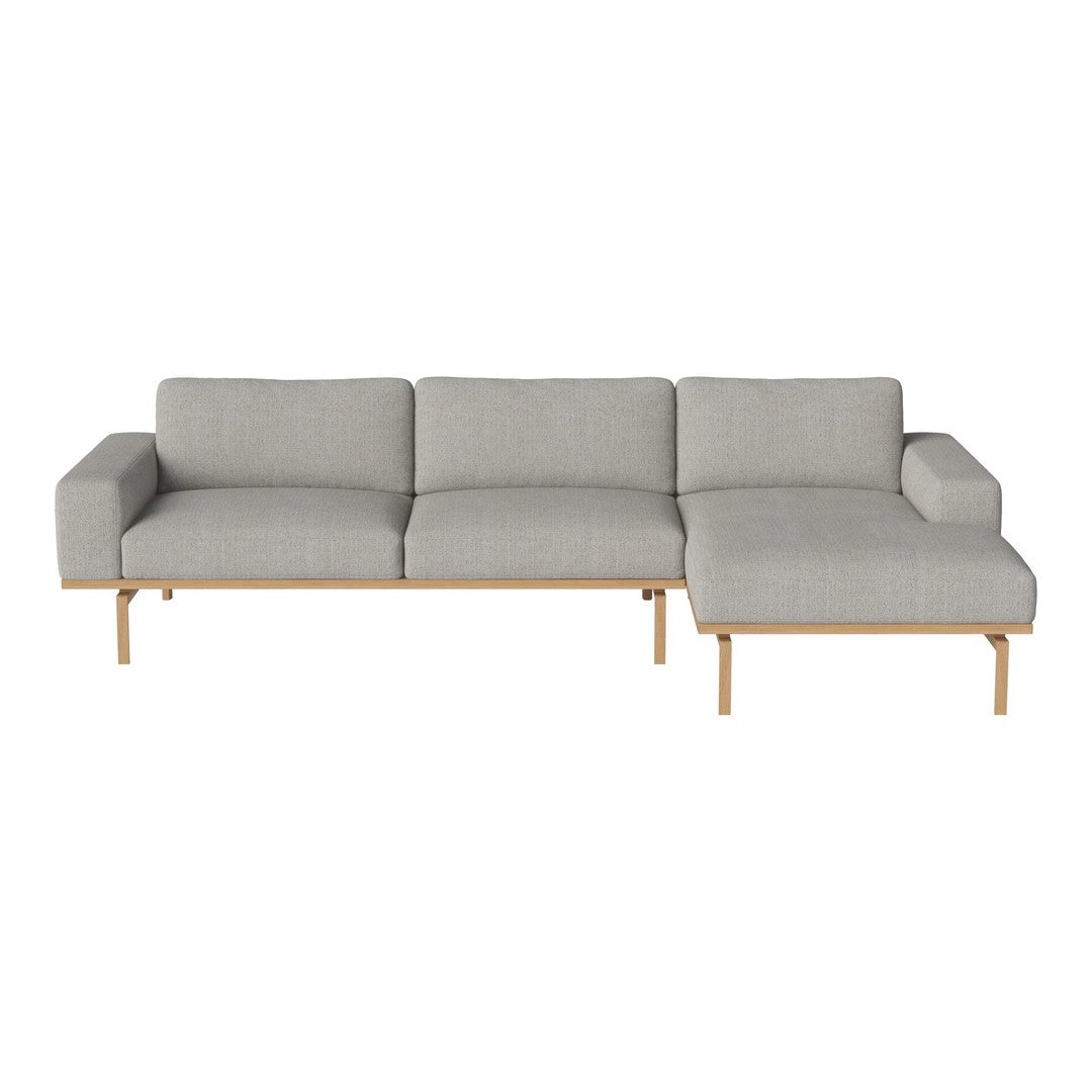 Light gray fabric sofa with a minimalist design, featuring smooth lines and a modern sectional layout.