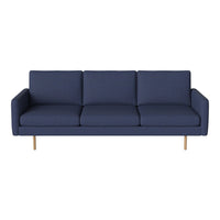 Navy blue upholstered sofa with clean lines and wooden legs, ideal for modern living spaces.