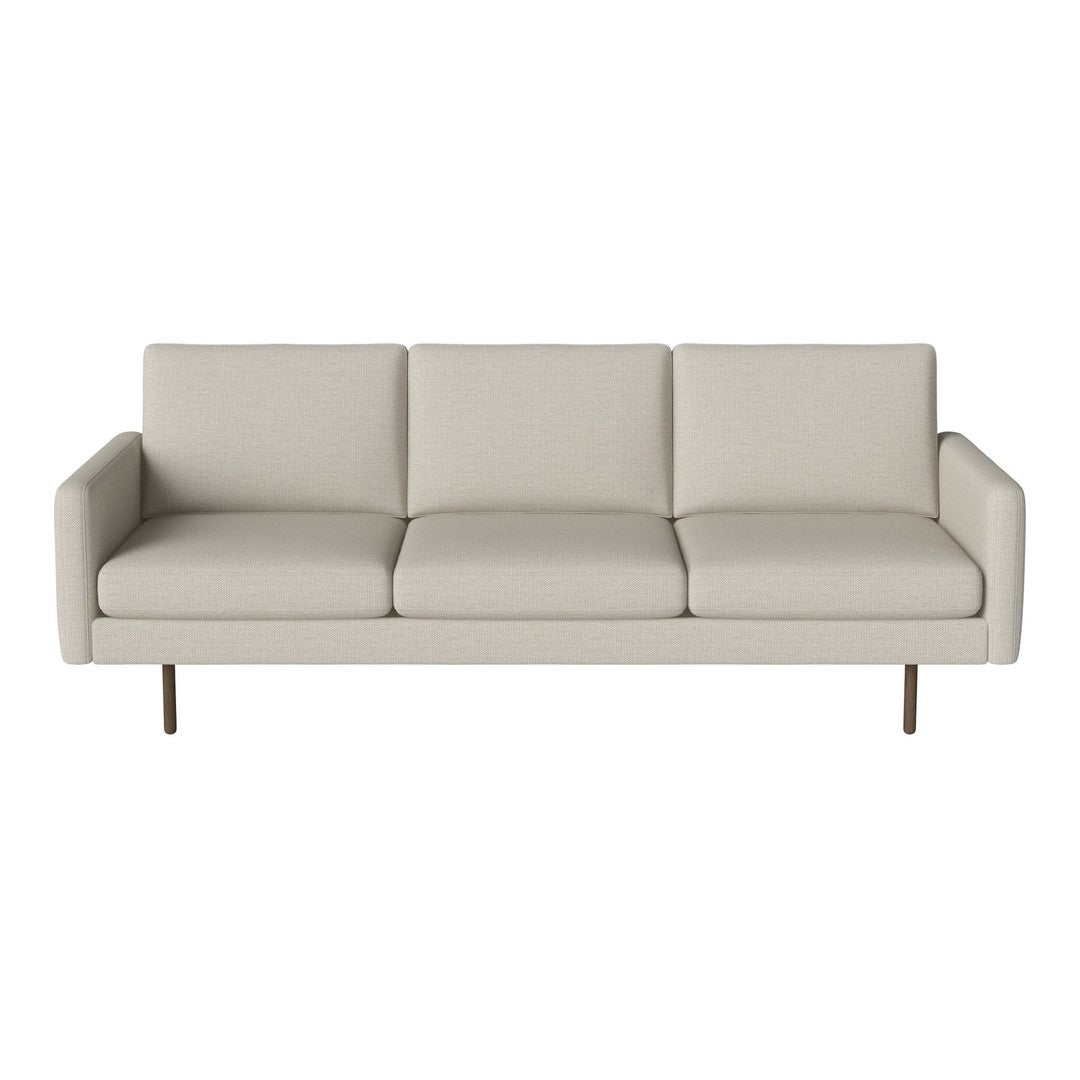 Light beige upholstered sofa with a minimalist design and smooth, solid-colored cushions.