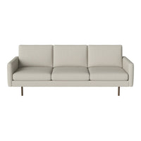 Light beige sofa with a minimalist design, featuring smooth, solid upholstery and sleek metal legs.
