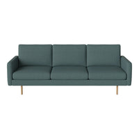 Teal upholstered sofa with a textured pattern and light wooden legs, adding a modern touch to any living space.