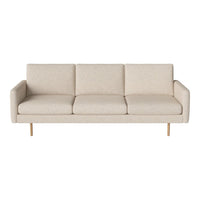 Light beige sofa with subtle textured pattern and sleek wooden legs, perfect for modern living spaces.