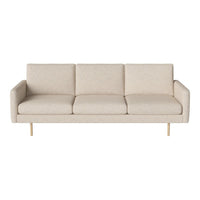 Cream-colored mid-century modern sofa with a simple, textured pattern and golden metal legs.