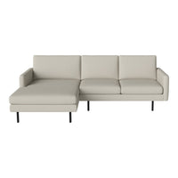 "Modern light gray sectional sofa with clean lines and smooth leather texture, featuring a sleek black metal base."