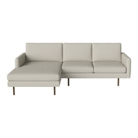 Light beige sectional sofa with sleek lines and a minimalist design, featuring smooth upholstery and metal legs.