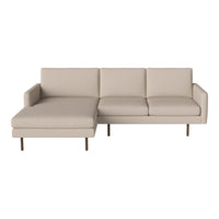 Beige sectional sofa with clean lines and minimalist design, featuring a smooth, textured upholstery and sleek metal legs.