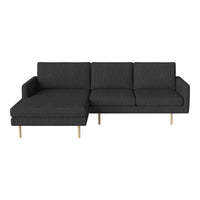 Modern sectional sofa in dark grey fabric with clean lines and light wooden legs, perfect for contemporary decor.