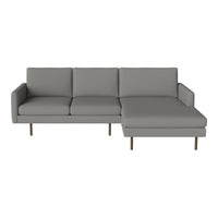 Modern gray sectional sofa with clean lines and minimalist design, featuring a plush fabric finish and sleek metal legs.