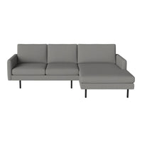Modern grey sectional sofa with smooth upholstery and sleek black legs, perfect for contemporary living spaces.