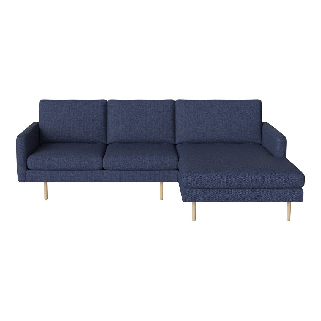 Navy blue sectional sofa with smooth fabric and light wooden legs, featuring a modern, minimalist design.