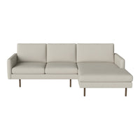 Light beige sectional sofa with sleek lines and minimalist design, featuring a solid color and no visible patterns.