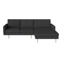 Dark gray upholstered sectional sofa with a sleek, modern design and wooden legs. Perfect for contemporary living spaces.