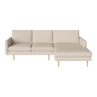Beige sectional sofa with simple, modern design and wooden legs, featuring a smooth, textured fabric upholstery.