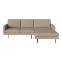 Beige sectional sofa with clean lines and a minimalist design, featuring a soft, textured fabric and sleek metal legs.