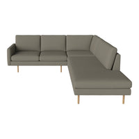 Modern sectional sofa in soft gray fabric with clean lines and natural wood legs, perfect for any living space.